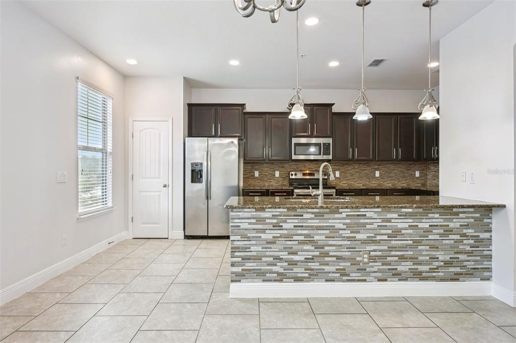 10866 Sunset Ridge Lane Orlando, FL 32832 - Photo 23 of 74 a view of a kitchen with refrigerator and microwave