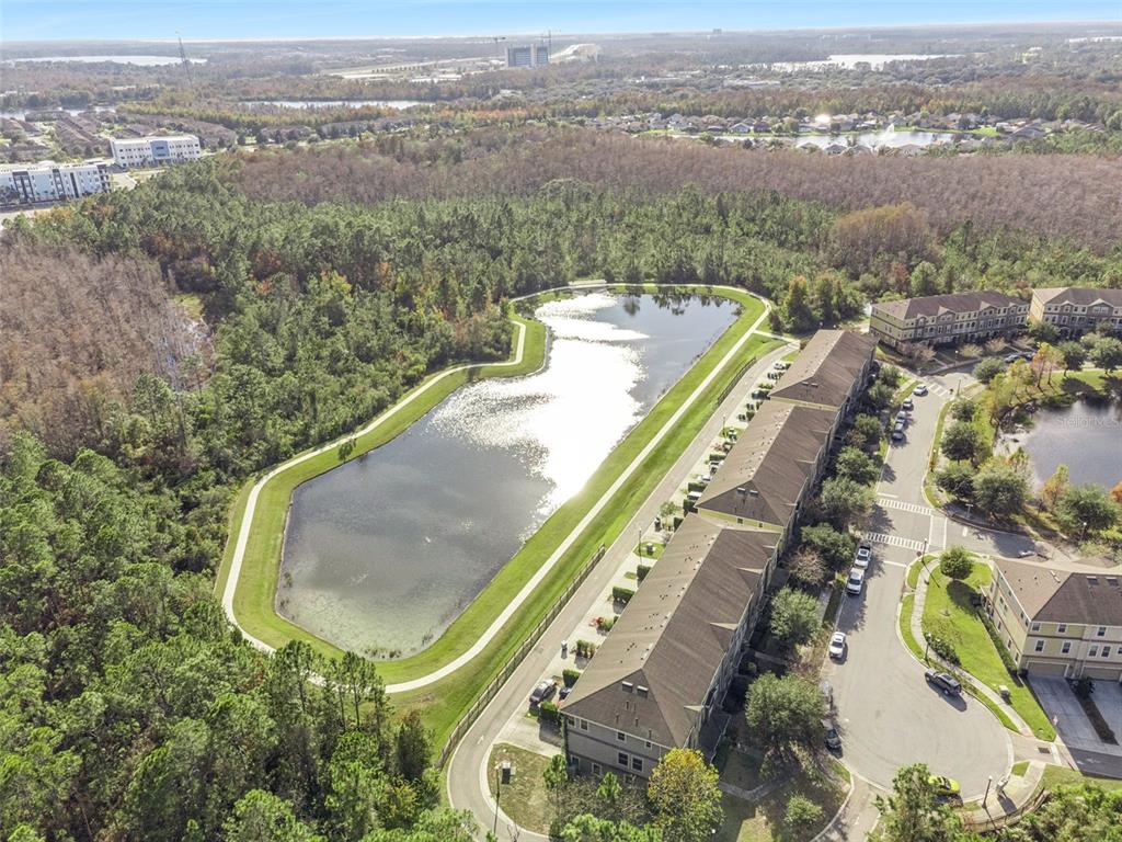 10866 Sunset Ridge Lane Orlando, FL 32832 - Photo 46 of 74 an aerial view of a residential houses with outdoor space and trees