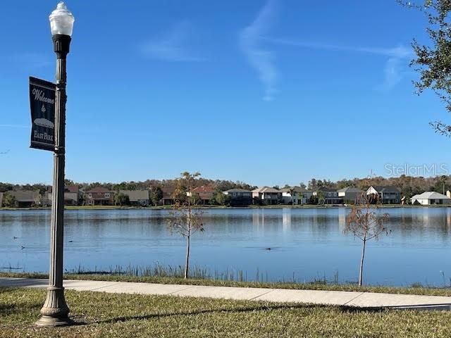 10866 Sunset Ridge Lane Orlando, FL 32832 - Photo 66 of 74 a view of a lake with houses in the background
