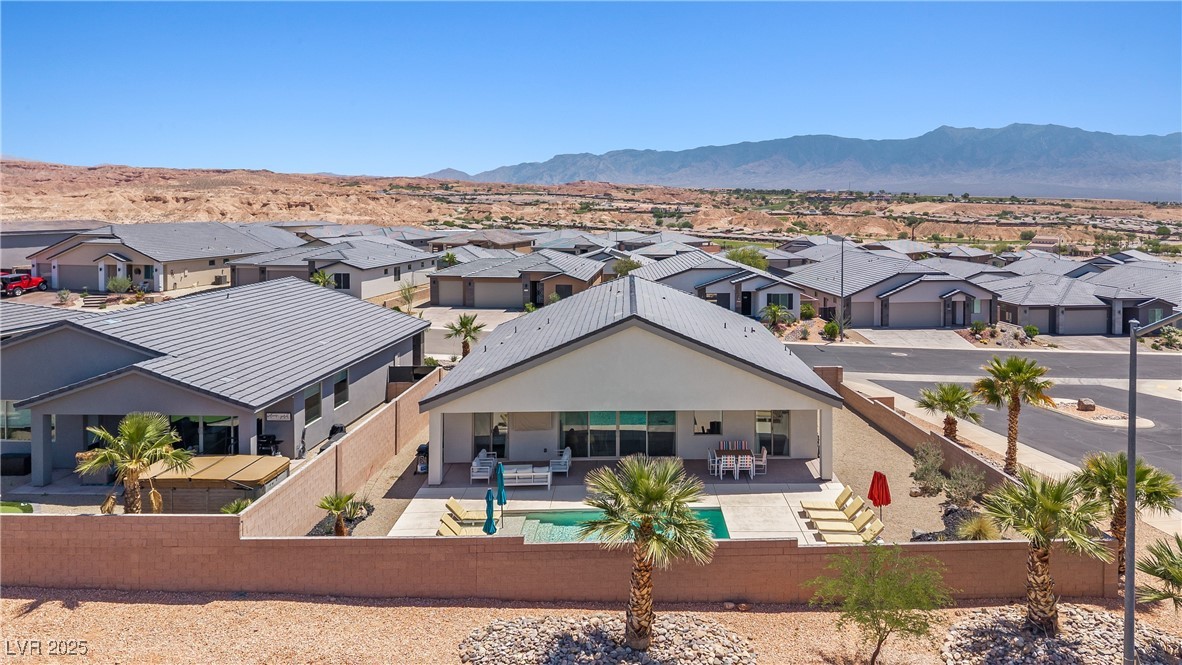 1357 Manassas Ridge Mesquite, NV 89027 - Photo 66 of 72 Back of house with a residential view, a fenced backyard, a patio area, and a mountain view