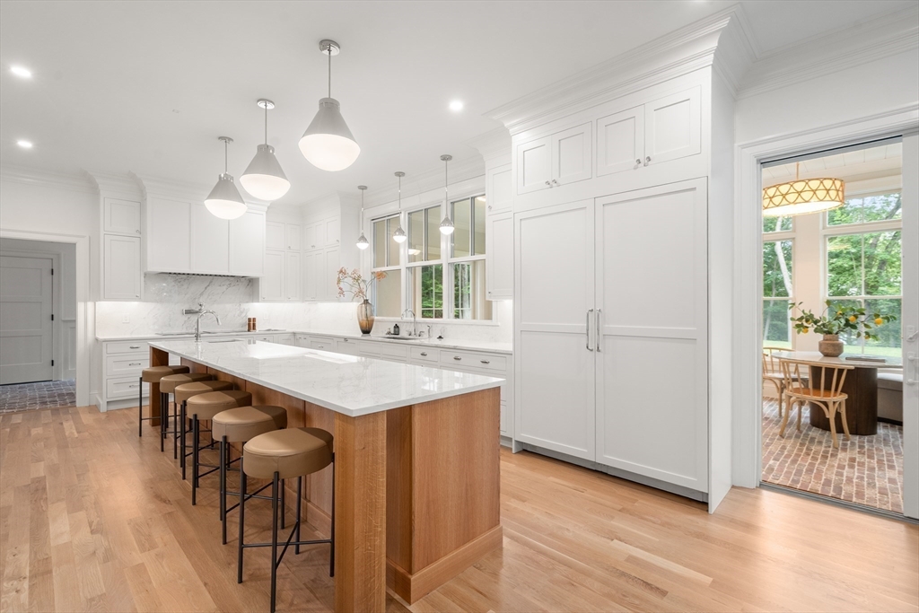 15 Lathrop Road Wellesley, MA 02482 - Photo 12 of 40 a kitchen with a table chairs refrigerator and cabinets