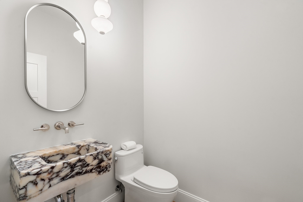 15 Lathrop Road Wellesley, MA 02482 - Photo 16 of 40 a bathroom with a sink a toilet and a mirror