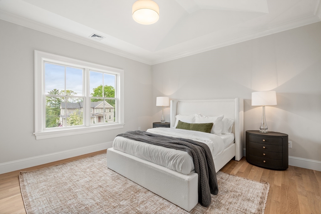 15 Lathrop Road Wellesley, MA 02482 - Photo 26 of 40 a spacious bedroom with a bed and a window