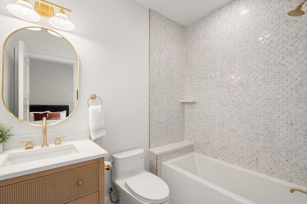 15 Lathrop Road Wellesley, MA 02482 - Photo 33 of 40 a bathroom with a sink toilet vanity and tub