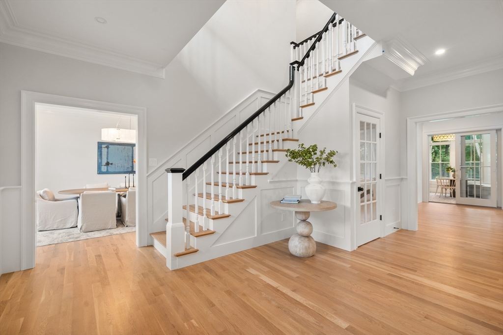 15 Lathrop Road Wellesley, MA 02482 - Photo 4 of 40 a view of an entryway with wooden floor and a living room