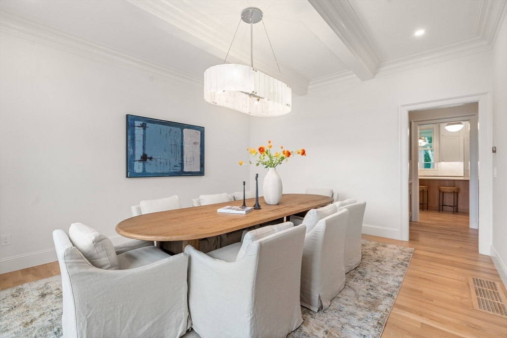 15 Lathrop Road Wellesley, MA 02482 - Photo 5 of 40 a dining room with wooden floor a chandelier a wooden table and chairs