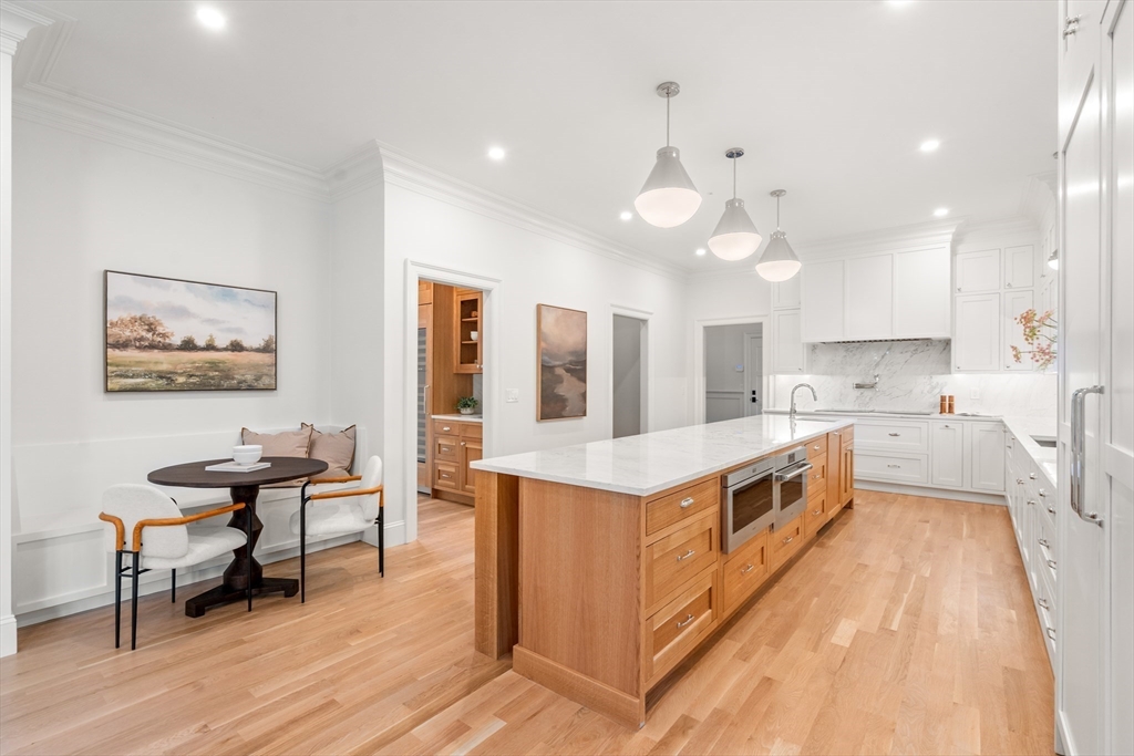 15 Lathrop Road Wellesley, MA 02482 - Photo 7 of 40 a kitchen with stainless steel appliances a stove a sink a kitchen island with wooden cabinets and floor