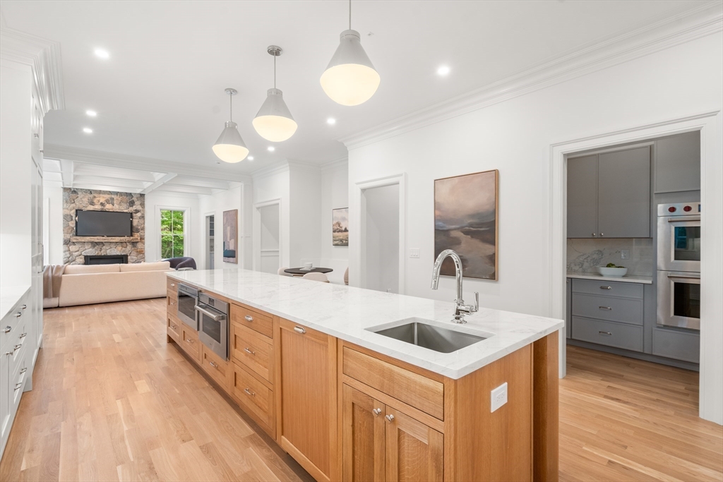 15 Lathrop Road Wellesley, MA 02482 - Photo 8 of 40 a large kitchen with stainless steel appliances a large counter top a sink and a refrigerator