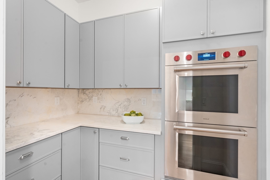 15 Lathrop Road Wellesley, MA 02482 - Photo 9 of 40 a kitchen with white cabinets and white appliances
