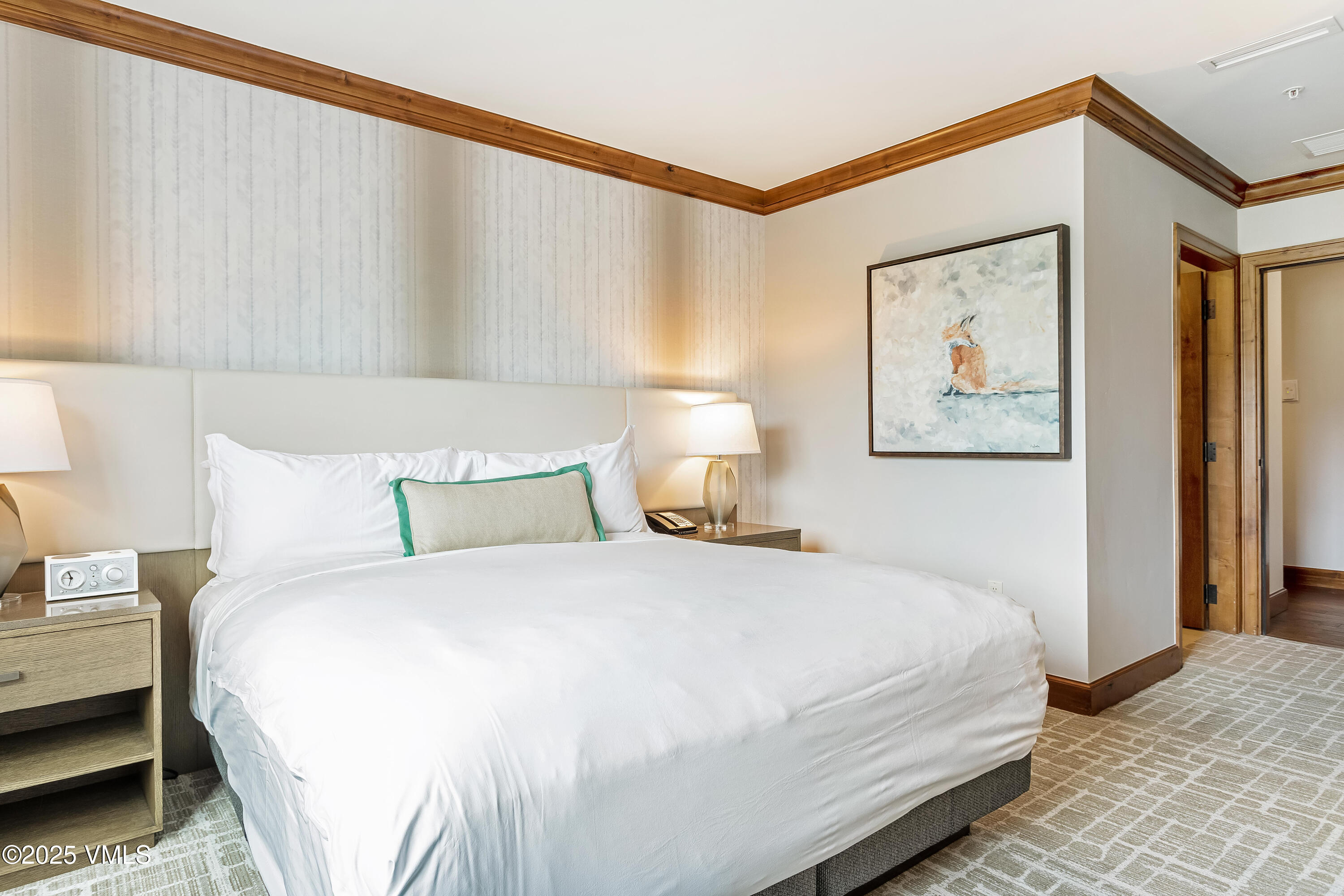 728 West Lionshead Circle, Unit F429 Vail, CO 81657 - Photo 13 of 25 a bedroom with a bed and a painting on the wall