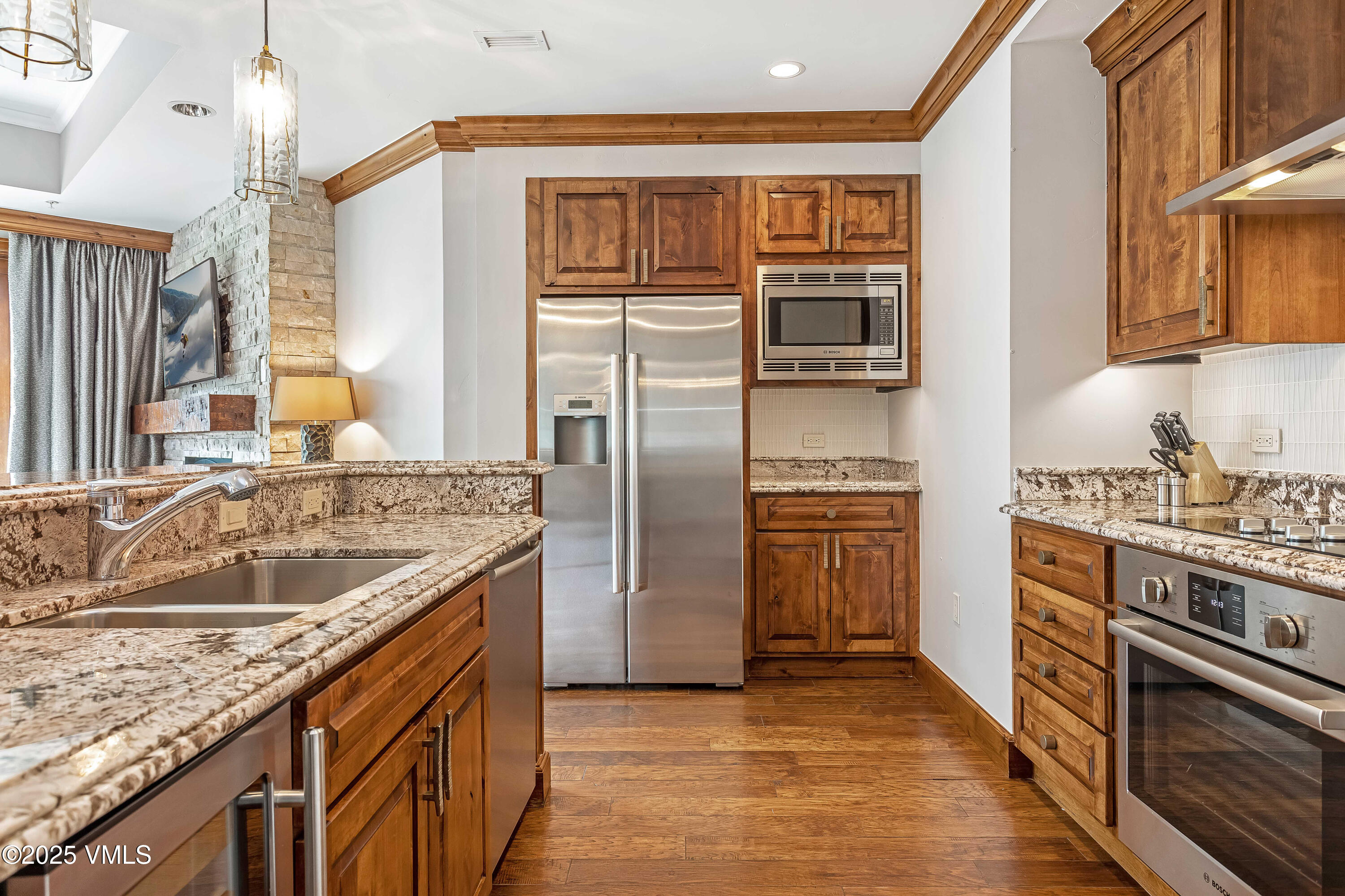 728 West Lionshead Circle, Unit F429 Vail, CO 81657 - Photo 17 of 25 a kitchen with stainless steel appliances granite countertop a sink stove and refrigerator