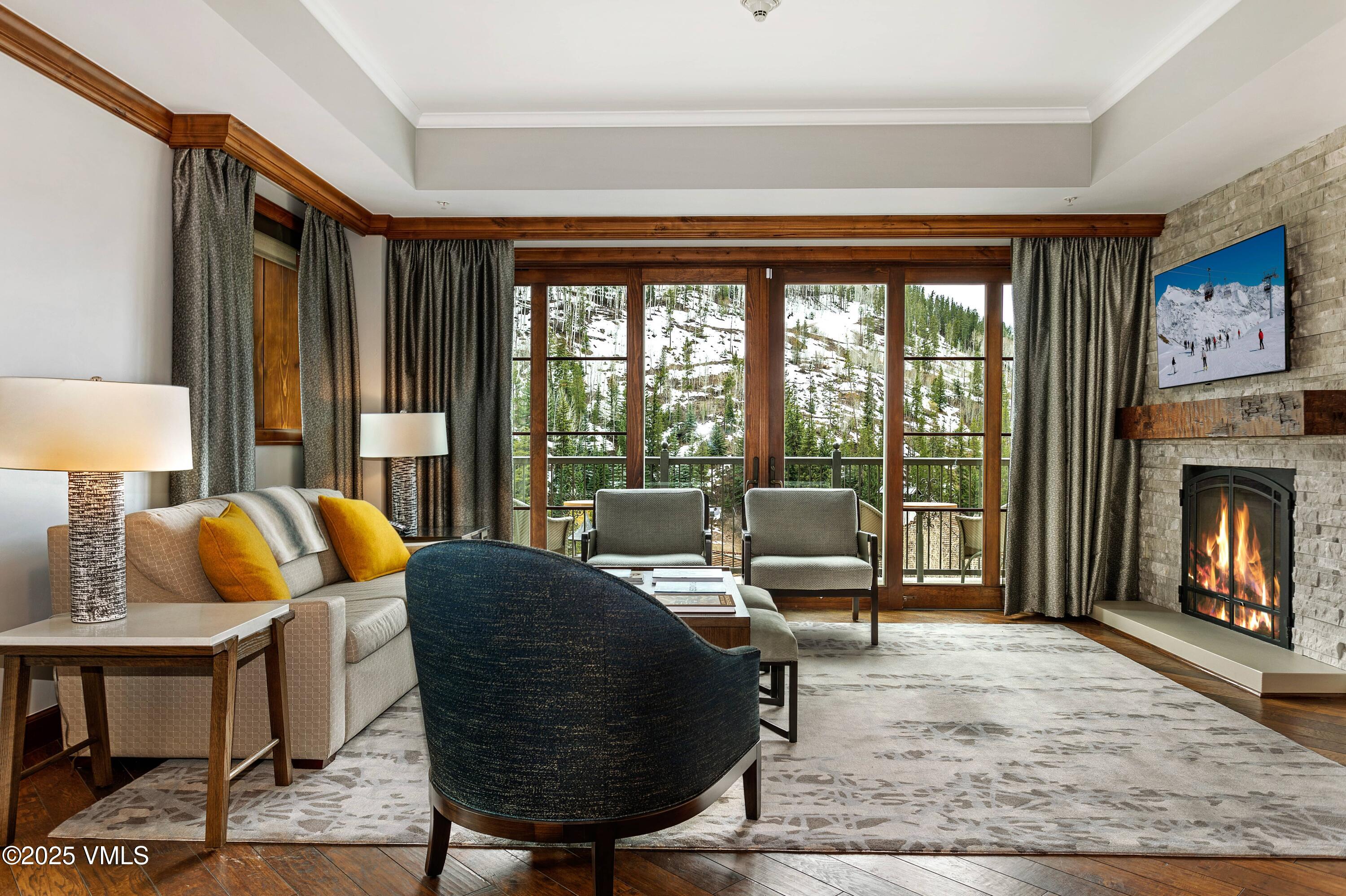 728 West Lionshead Circle, Unit F429 Vail, CO 81657 - Photo 18 of 25 a living room with furniture and a fireplace