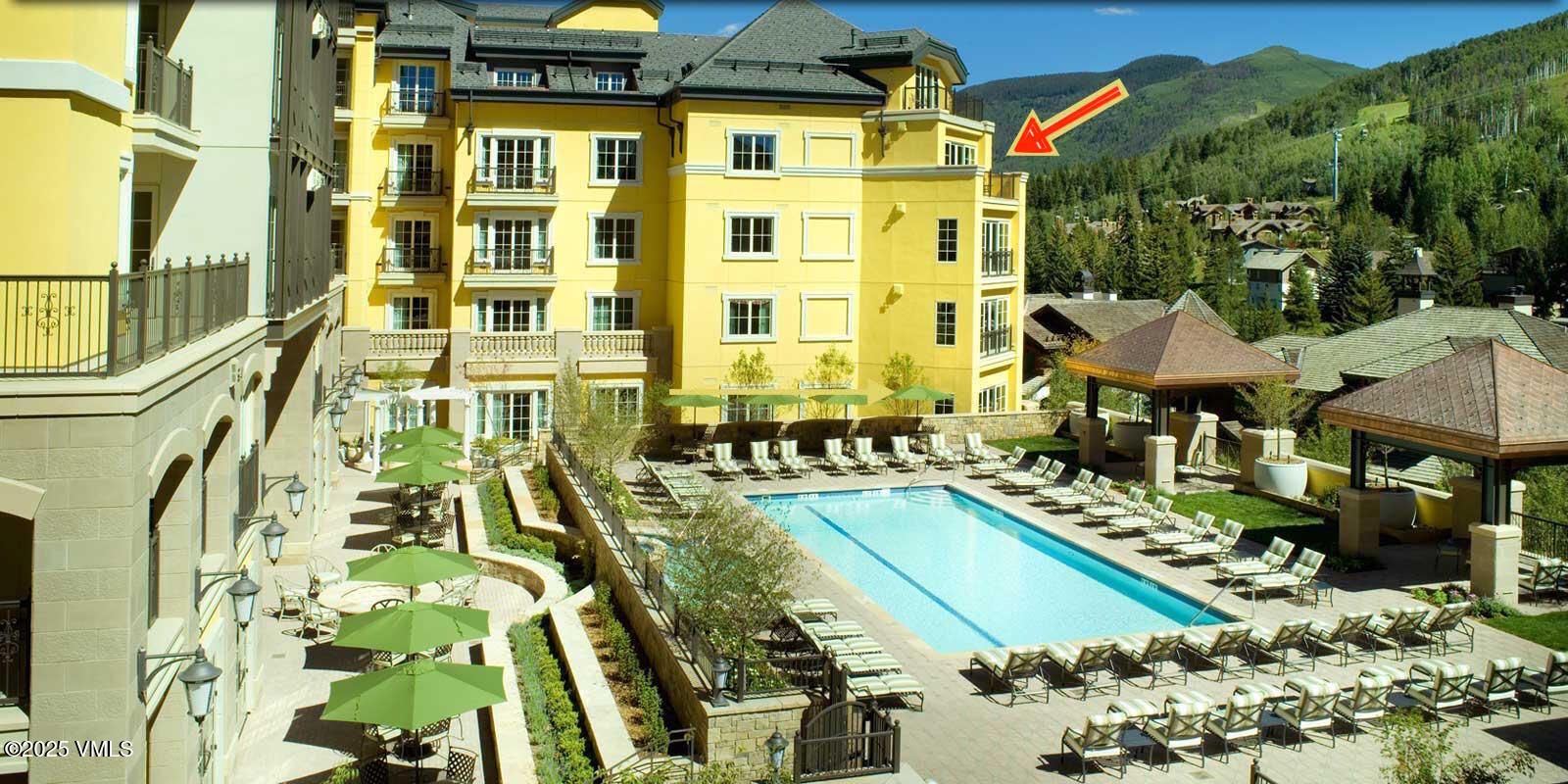 728 West Lionshead Circle, Unit F429 Vail, CO 81657 - Photo 2 of 25 a front view of a residential apartment building with a yard