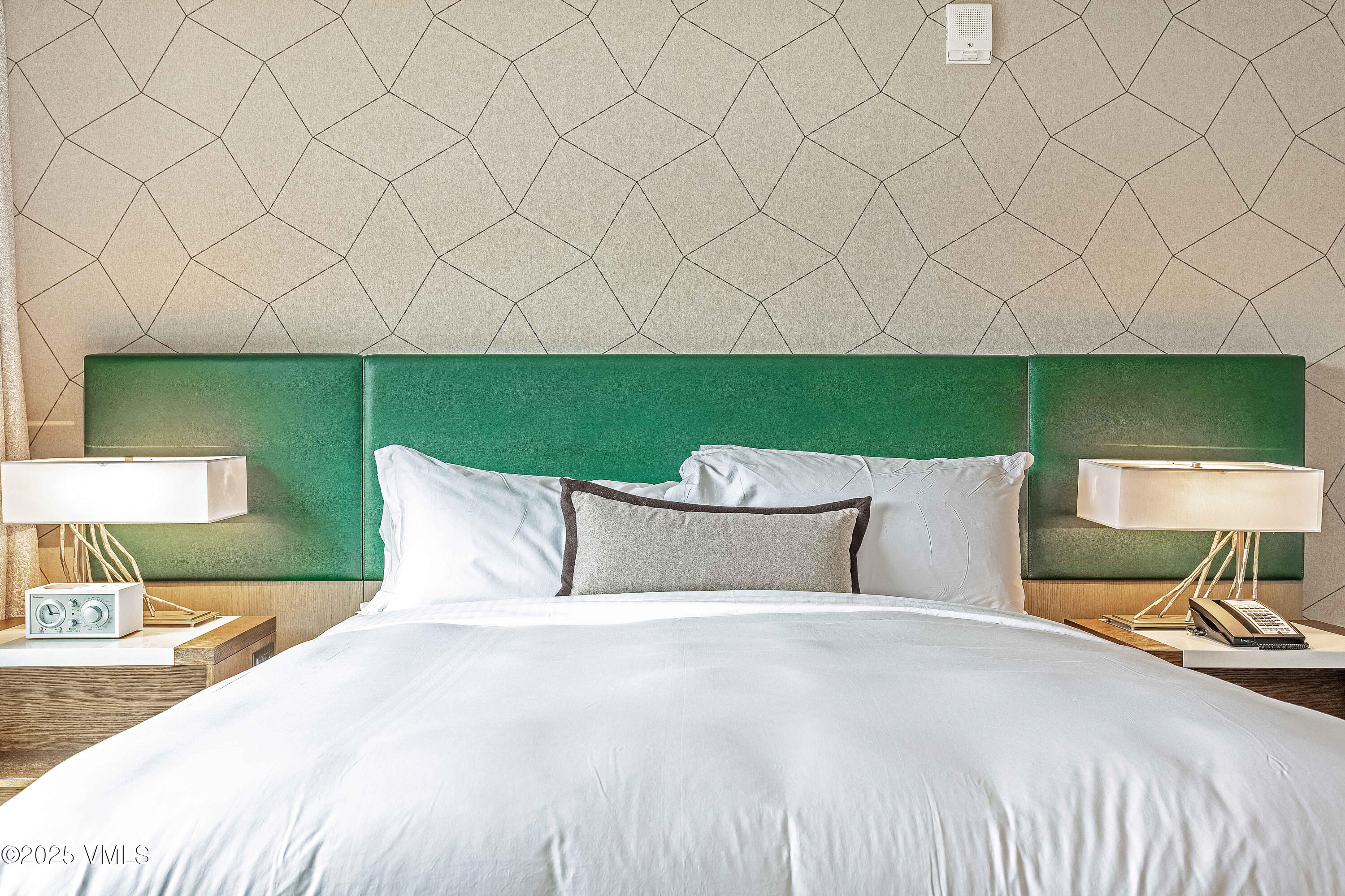 728 West Lionshead Circle, Unit F429 Vail, CO 81657 - Photo 5 of 25 a bed room with a bed and a chair