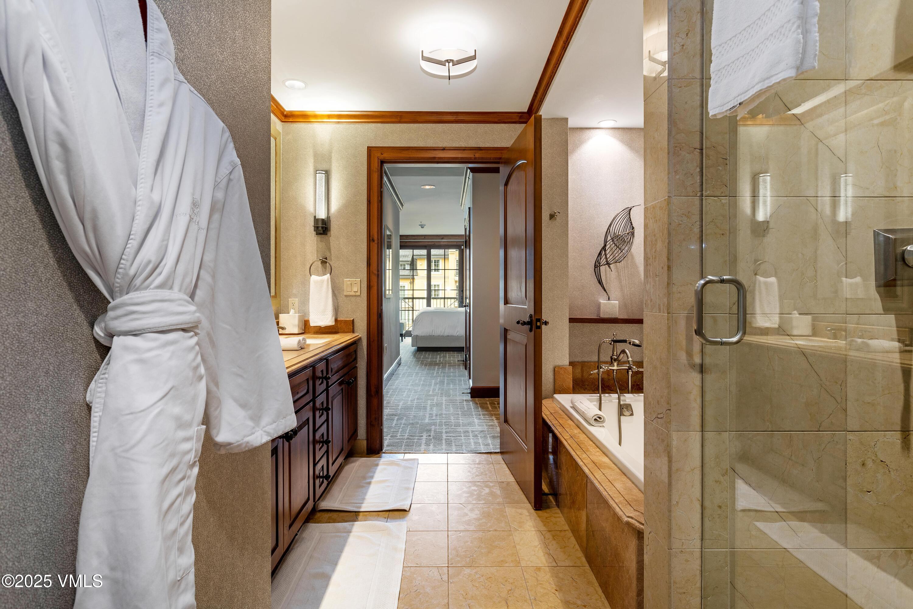 728 West Lionshead Circle, Unit F429 Vail, CO 81657 - Photo 8 of 25 a bathroom with a tub and shower