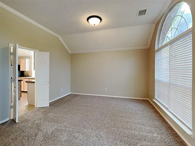 an empty room with large windows