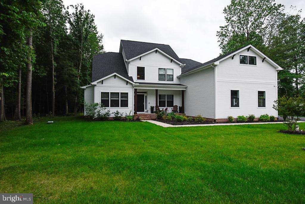a view of a yard in front of a house with green space