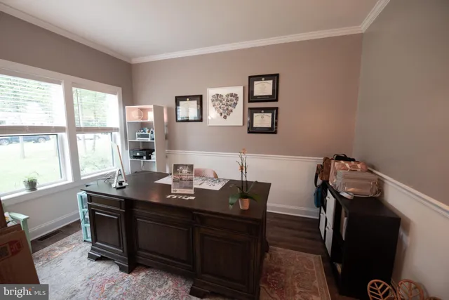 a room with a table chairs and wooden floor