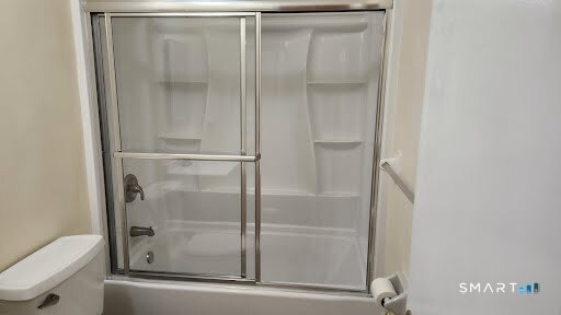 a bathroom with a glass shower door