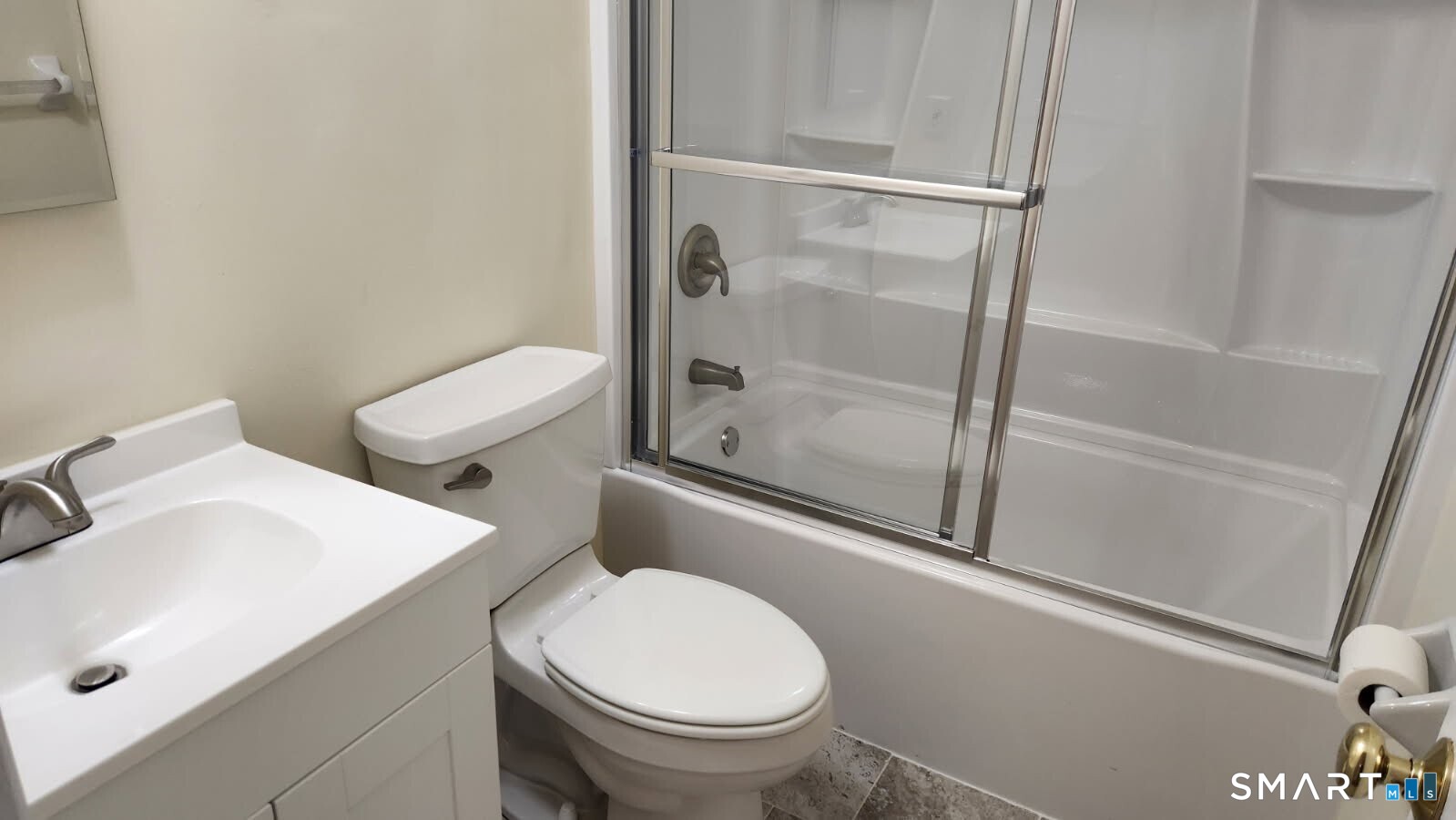 115 Short Beach Road, Unit 304 Stratford, CT 06615 - Photo 12 of 26 a white toilet sitting next to a bath tub