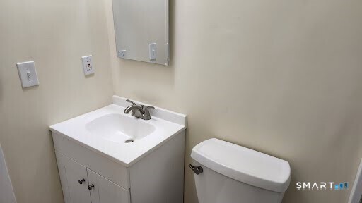 115 Short Beach Road, Unit 304 Stratford, CT 06615 - Photo 13 of 26 a white toilet sitting next to a white sink