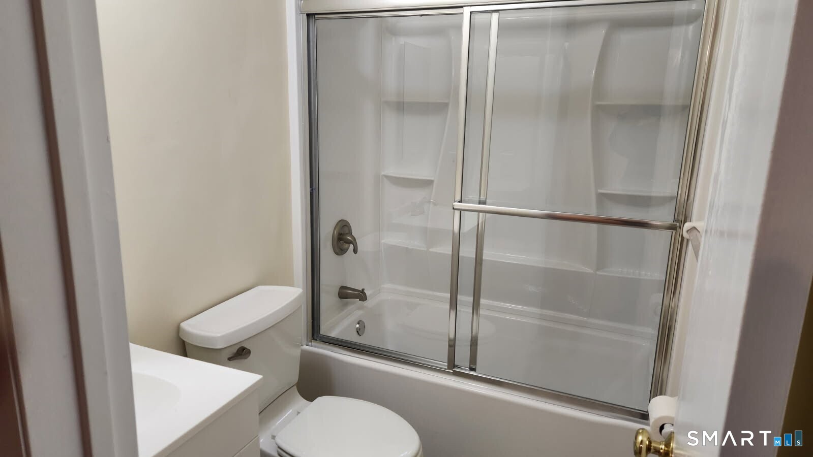 115 Short Beach Road, Unit 304 Stratford, CT 06615 - Photo 14 of 26 a bathroom with a granite countertop toilet and a shower