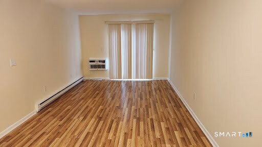 115 Short Beach Road, Unit 304 Stratford, CT 06615 - Photo 18 of 26 a view of a room with wooden floor and bench