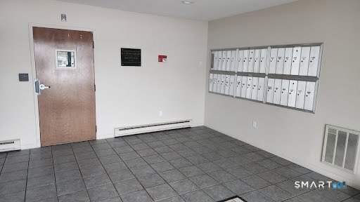 115 Short Beach Road, Unit 304 Stratford, CT 06615 - Photo 4 of 26 a view of an empty room with windows