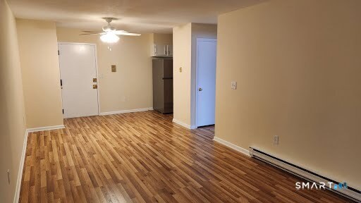 115 Short Beach Road, Unit 304 Stratford, CT 06615 - Photo 9 of 26 a view of an empty room with wooden floor