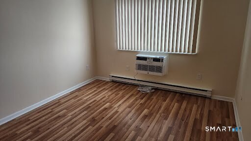 115 Short Beach Road, Unit 304 Stratford, CT 06615 - Photo 10 of 26 a view of a room with wooden floor and bench