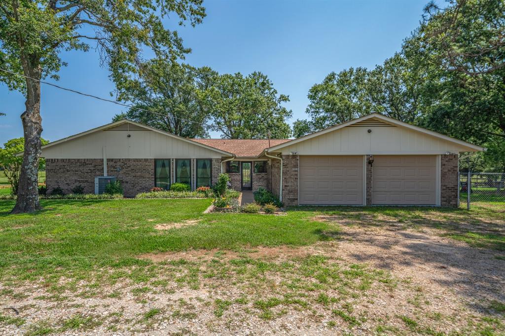776 County Road 3209 Wills Point, TX 75169 - Photo 12 of 40 a front view of a house with a yard and garage