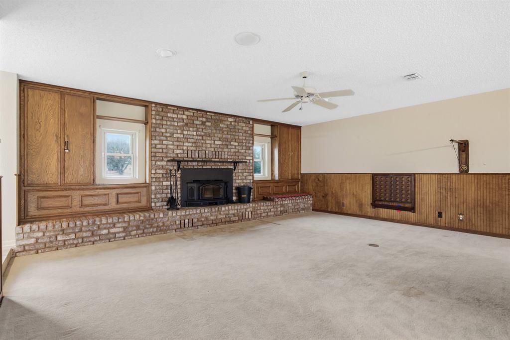 776 County Road 3209 Wills Point, TX 75169 - Photo 13 of 40 a living room with furniture and a fireplace