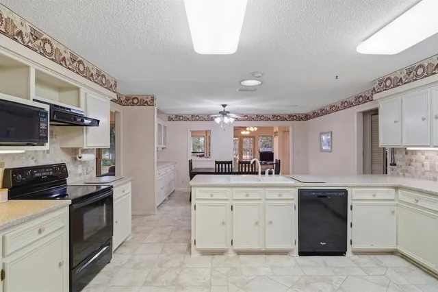 a kitchen with a sink stove and cabinets