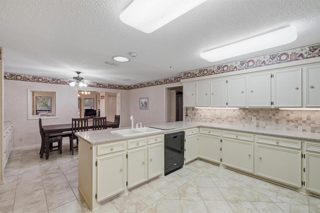 776 County Road 3209 Wills Point, TX 75169 - Photo 17 of 40 a kitchen with a sink and cabinets