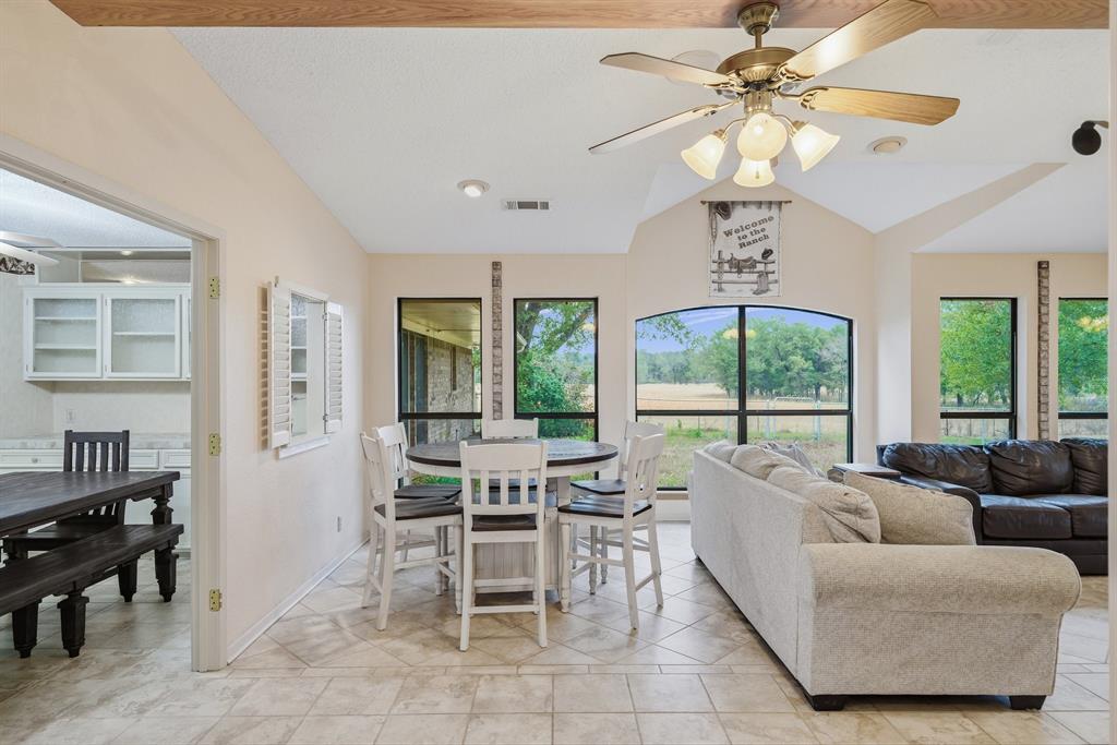 776 County Road 3209 Wills Point, TX 75169 - Photo 21 of 40 a living room with furniture a chandelier and a large window