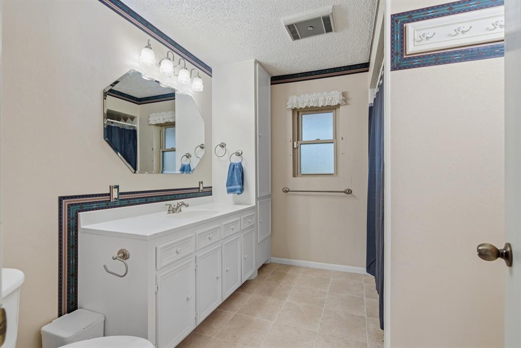 776 County Road 3209 Wills Point, TX 75169 - Photo 26 of 40 a bathroom with a sink a toilet and mirror