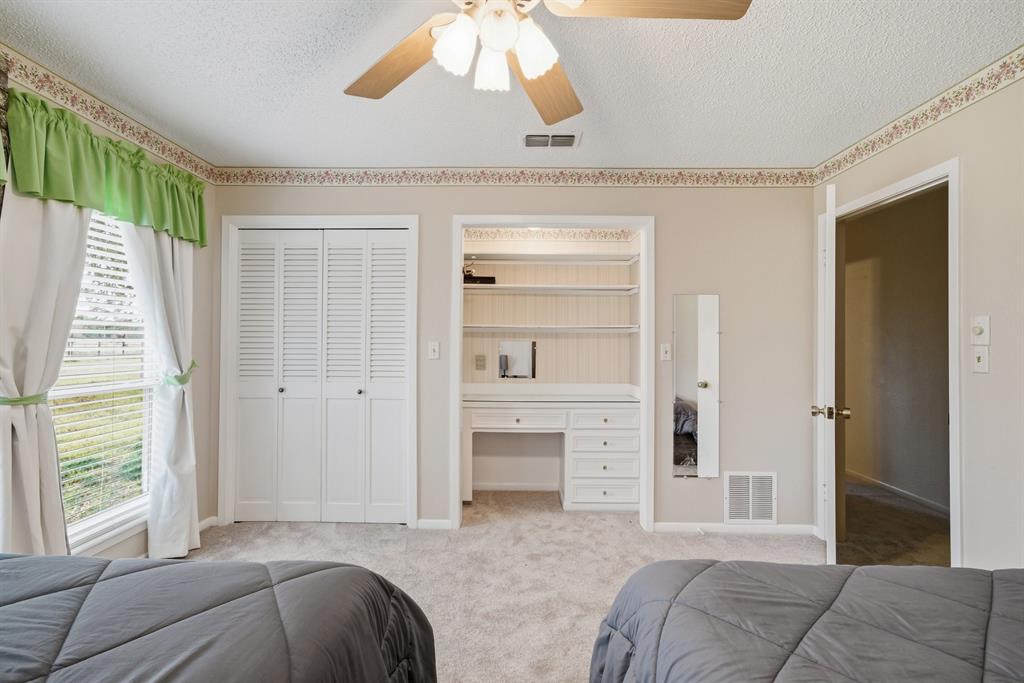 776 County Road 3209 Wills Point, TX 75169 - Photo 29 of 40 a spacious bedroom with a bed and a chandelier