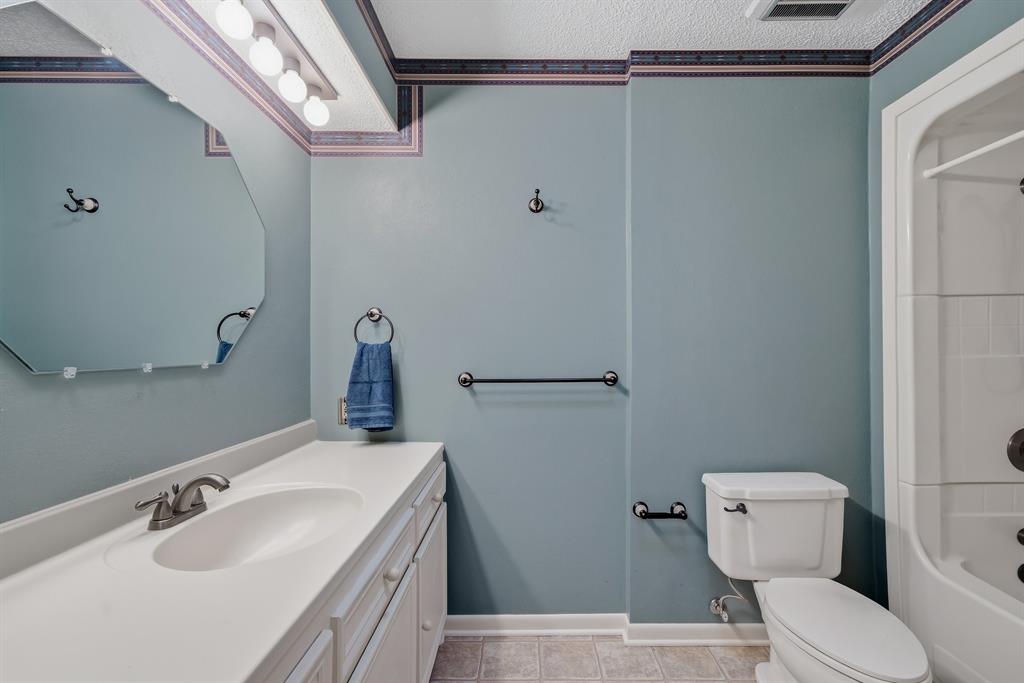 776 County Road 3209 Wills Point, TX 75169 - Photo 30 of 40 a bathroom with a sink a toilet and shower