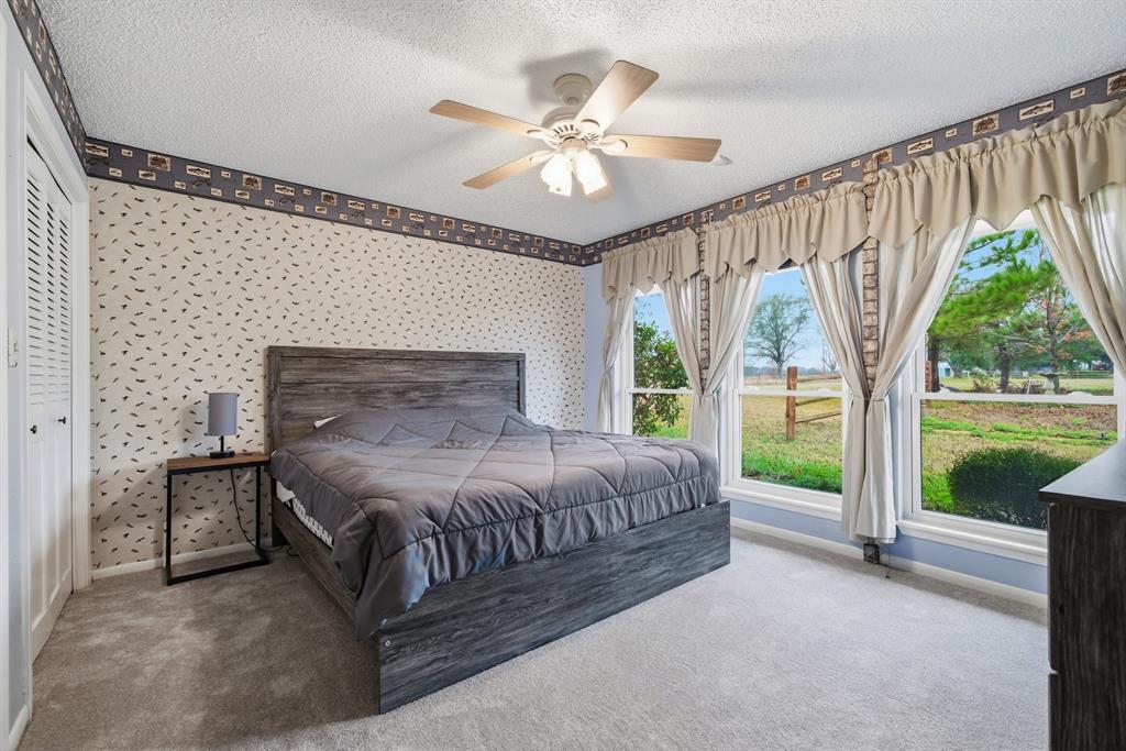 776 County Road 3209 Wills Point, TX 75169 - Photo 32 of 40 a bedroom with a bed and a large window with outer view