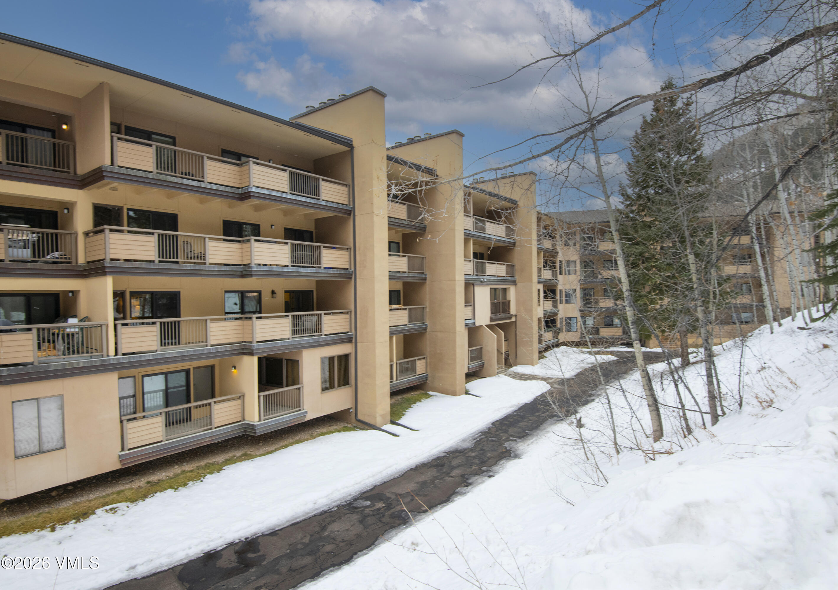 1650 Fall Ridge Road, Unit 202 Vail, CO 81657 - Photo 27 of 32 a view of a large building with a lot of windows