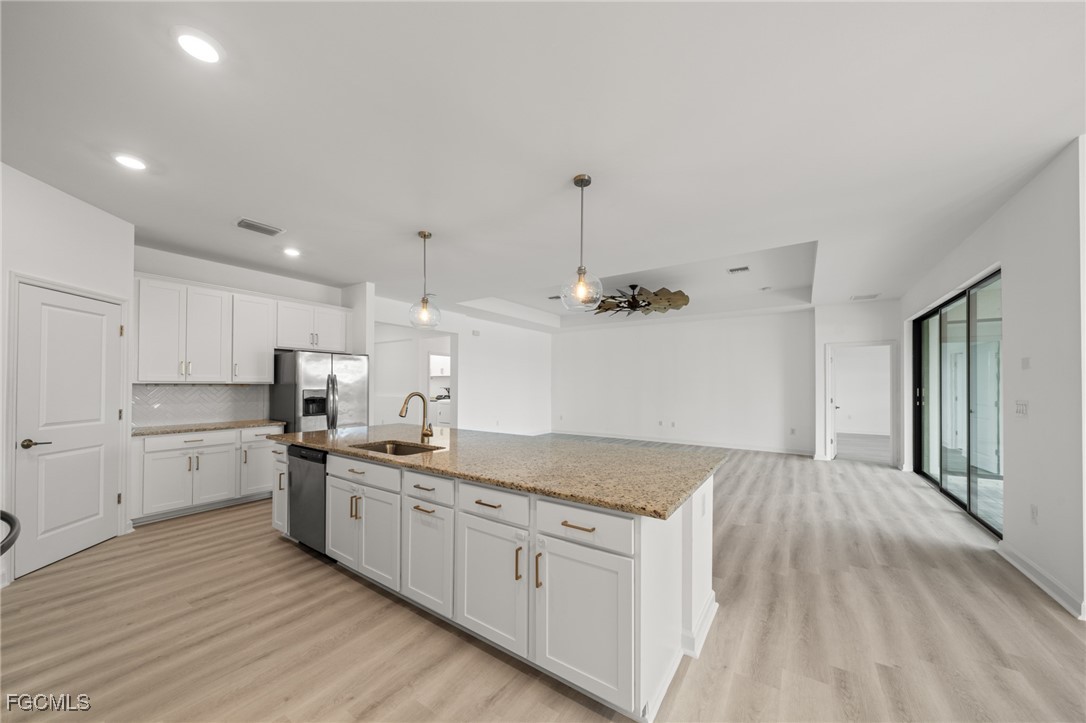 11559 Canopy Loop Fort Myers, FL 33913 - Photo 15 of 50 a kitchen with white cabinets and sink