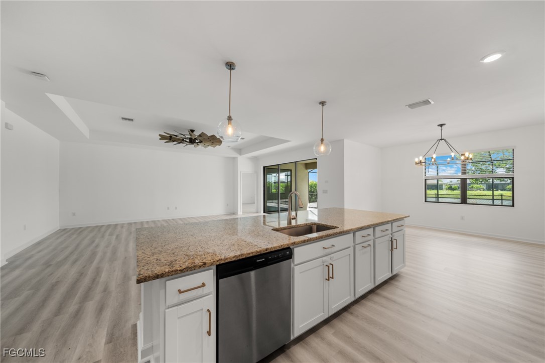 11559 Canopy Loop Fort Myers, FL 33913 - Photo 20 of 50 a view of a kitchen counter space a sink and dishwasher with wooden floor