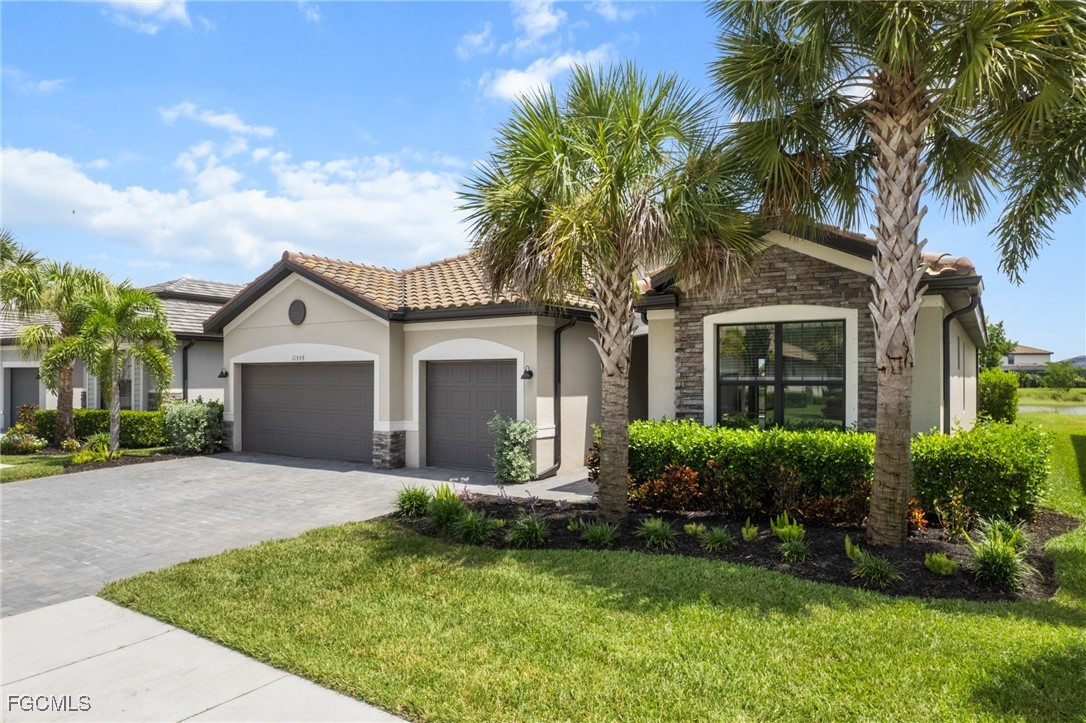 11559 Canopy Loop Fort Myers, FL 33913 - Photo 2 of 50 a front view of house with yard and green space