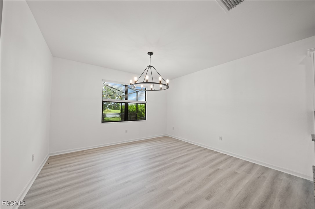 11559 Canopy Loop Fort Myers, FL 33913 - Photo 23 of 50 a view of room with window and hardwood floor