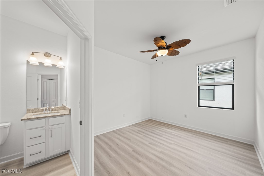 11559 Canopy Loop Fort Myers, FL 33913 - Photo 28 of 50 wooden floor in an empty room with a window