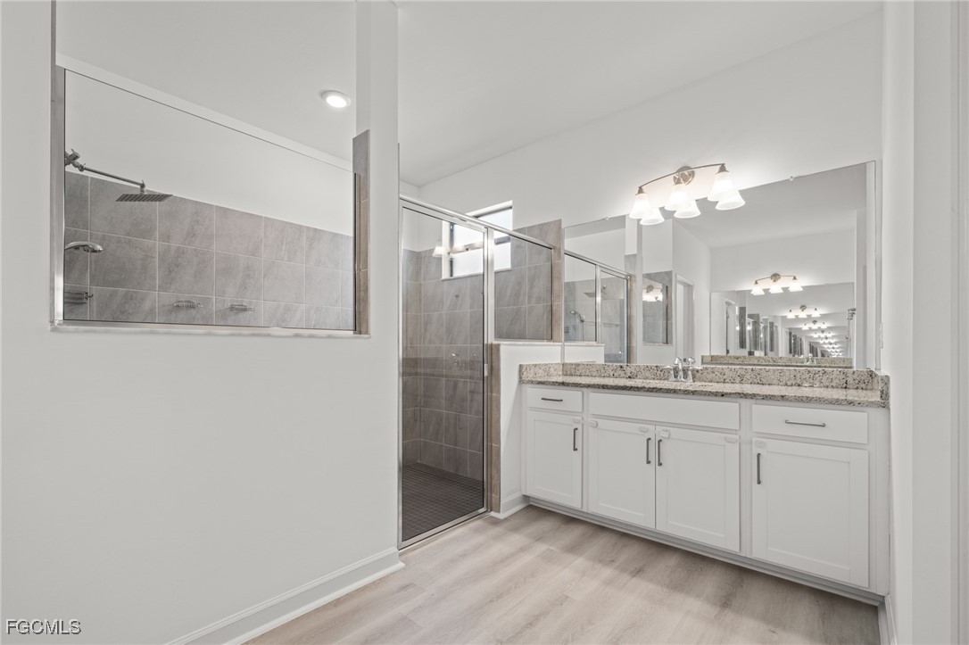 11559 Canopy Loop Fort Myers, FL 33913 - Photo 30 of 50 a bathroom with a double vanity sink and a mirror