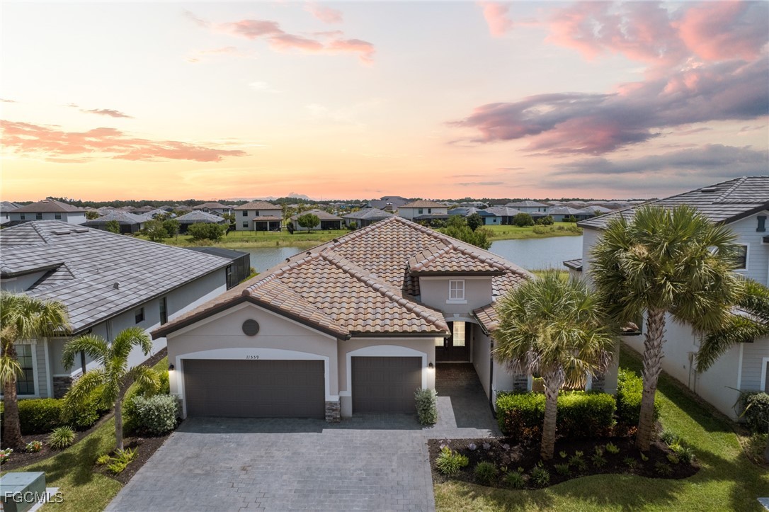 11559 Canopy Loop Fort Myers, FL 33913 - Photo 3 of 50 a view of a house with a yard and potted plants