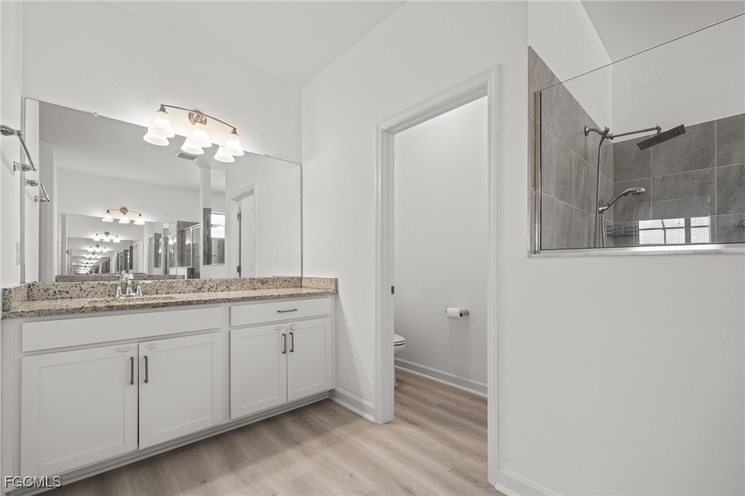 11559 Canopy Loop Fort Myers, FL 33913 - Photo 31 of 50 a bathroom with a double vanity sink and a mirror