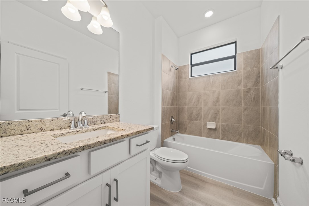 11559 Canopy Loop Fort Myers, FL 33913 - Photo 32 of 50 a bathroom with a granite countertop sink a toilet and bathtub