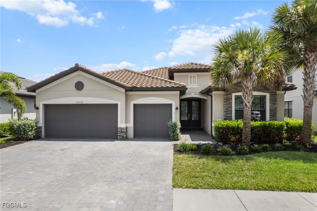 11559 Canopy Loop Fort Myers, FL 33913 - Photo 4 of 50 a front view of a house with garden